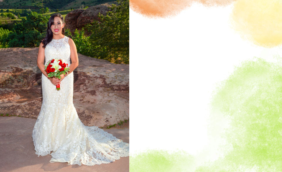 Beautiful bride holding red and white flowers in a nature setting
