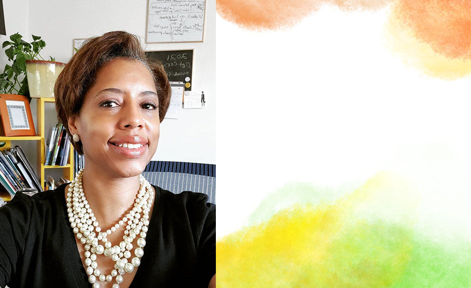 Elegant woman wearing Rhoda Design Group Warm Executive Makeup Kit and pearls in an office setting